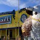 front of the big texan restaurant with giant cute cow statue